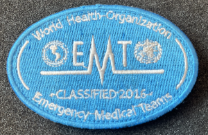 Blue embroidered WHO patch reading “World Health Organization – EMT – Classified 2016 – Emergency Medical Teams.”